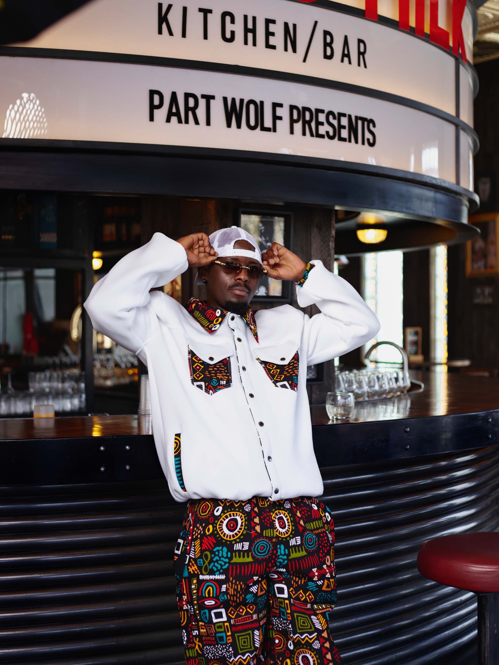 Takura wearing a byBAKARI Pariah Collection jacket featuring a contemporary Ankara print, created in collaboration between Shona Prince and #byBAKARI. Created #byBAKARI. Made In Zimbabwe